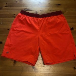 Two pairs of Fabletics workout shorts- blue and orange
